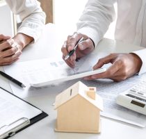 Real estate broker agent presenting and consult to customer to d Real estate broker agent presenting and consult to customer to decision making sign insurance form agreement, home model, concerning mortgage loan offer for and house insurance.
